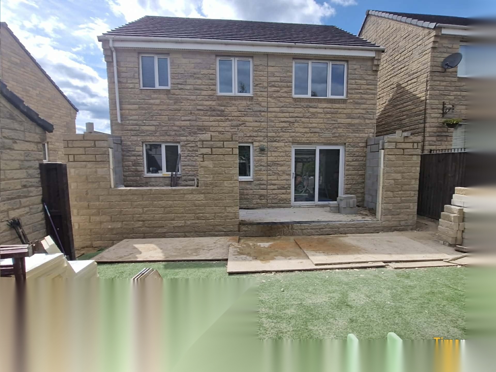 Stone-faced rear extension and garden walls nearing completion on a South Yorkshire property