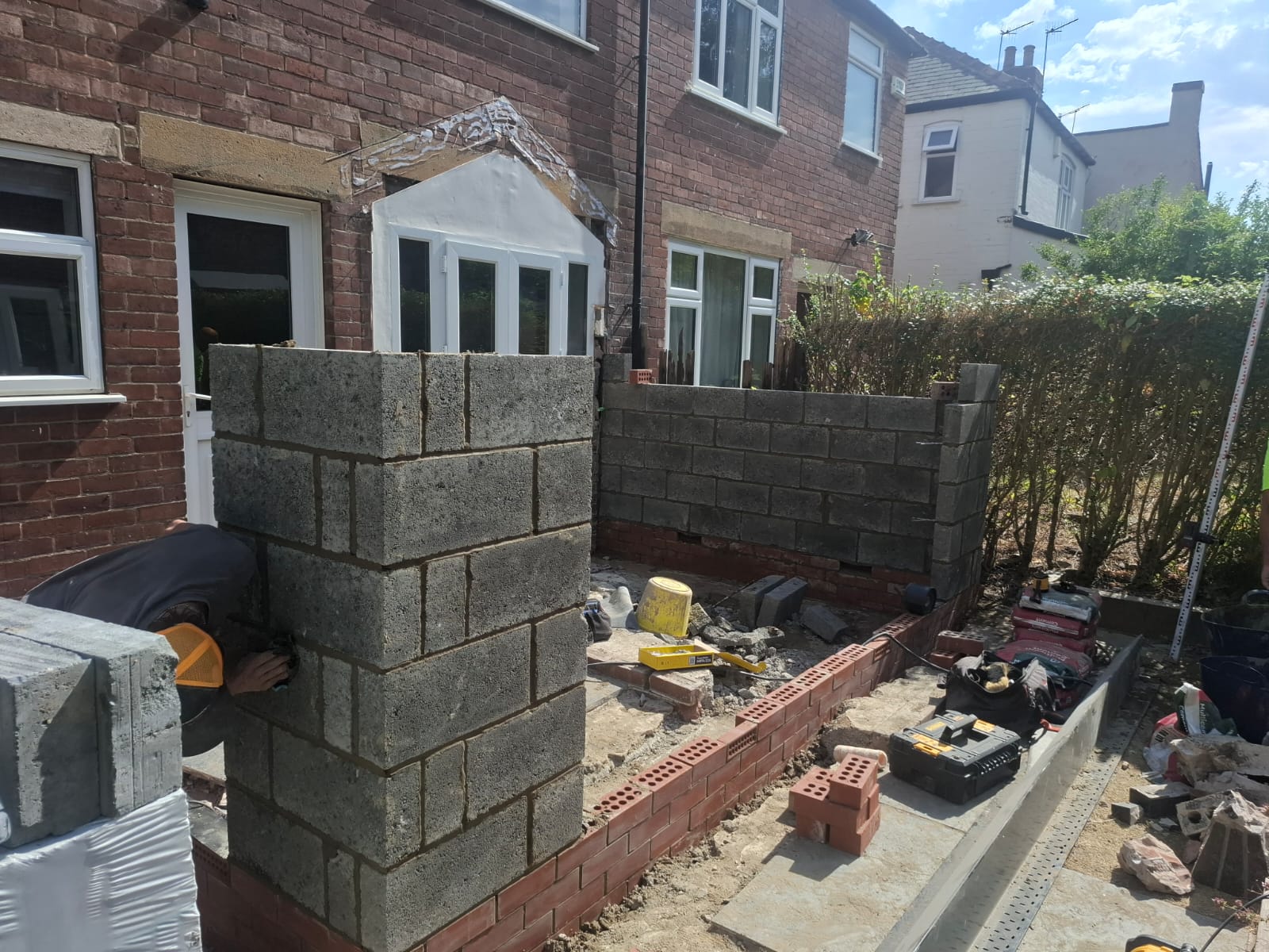Garden wall being built in blockwork and brick courses around a residential garden in South Yorkshire