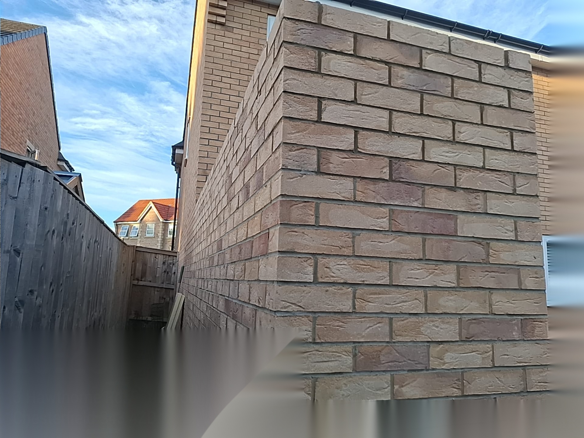 Newly built buff brick boundary wall running alongside a residential garden in Doncaster