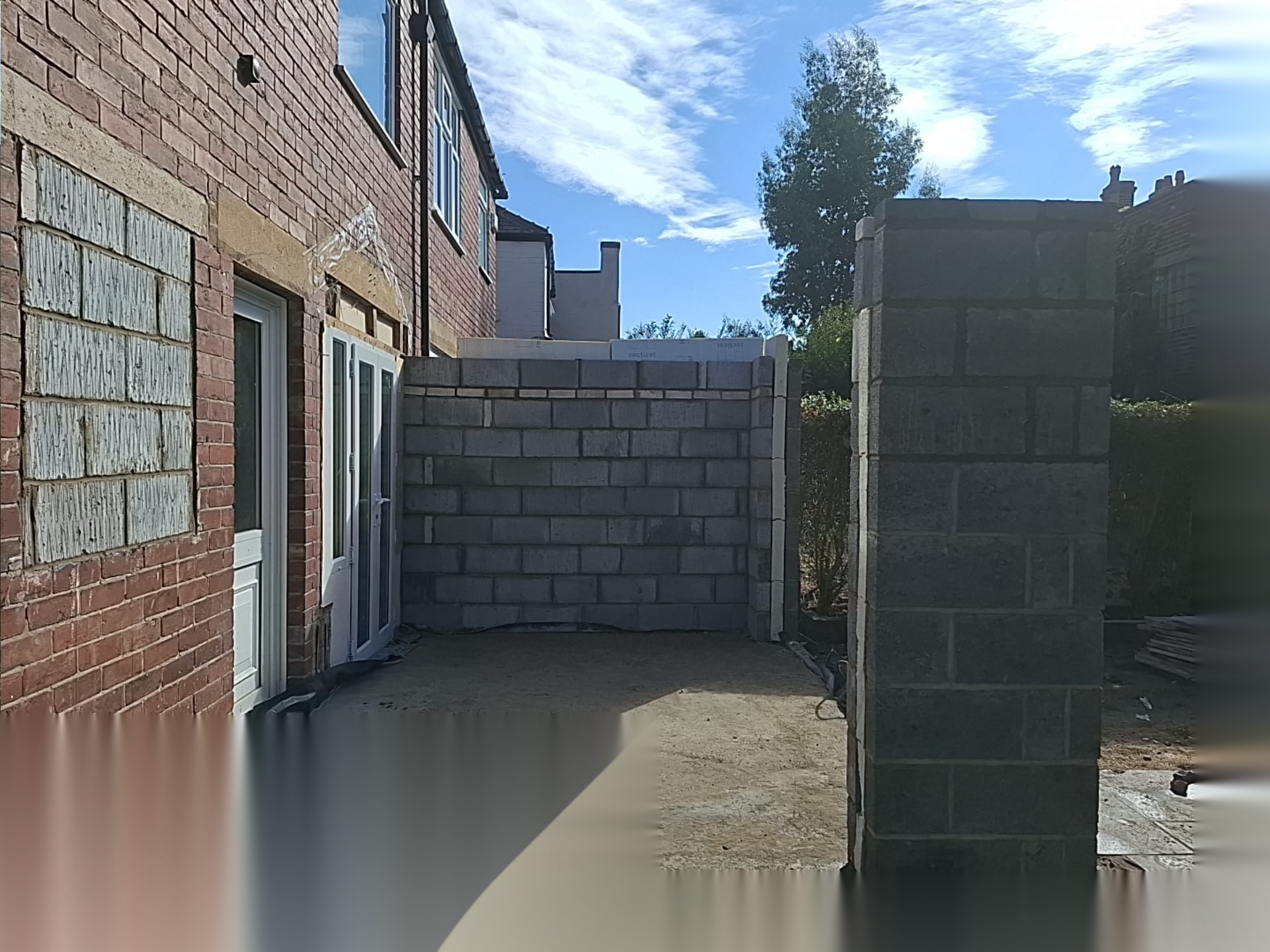 Block boundary wall being built beside an older brick building during a Doncaster brickwork project