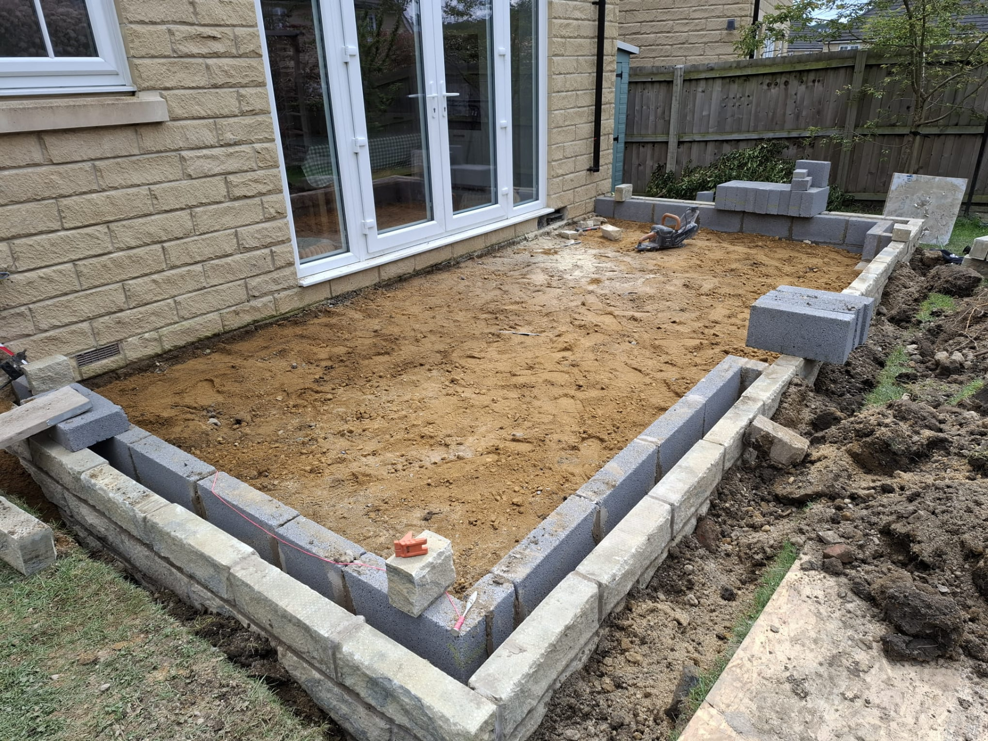 Patio area excavated with blockwork edging installed ready for the paving build-up