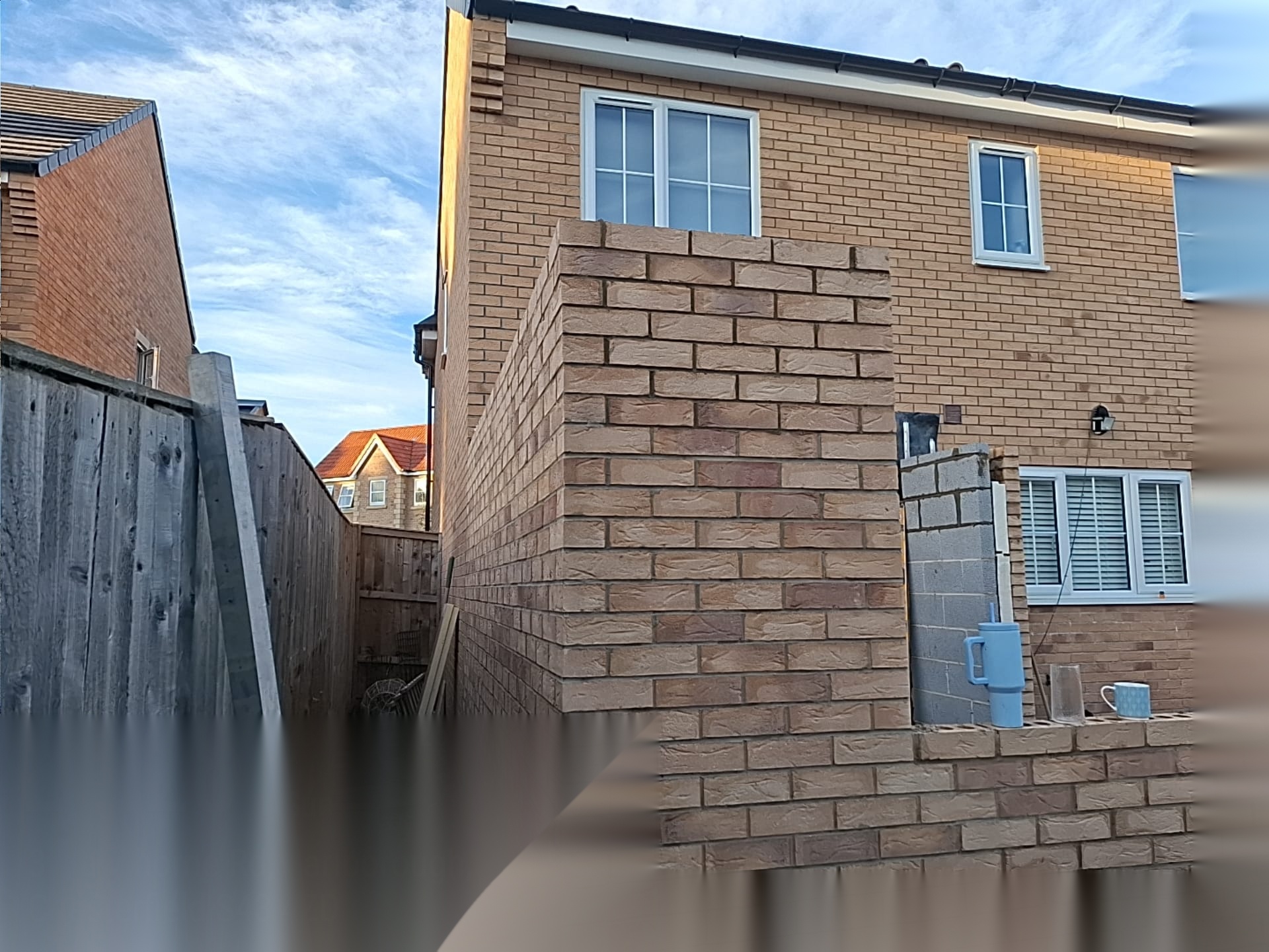 Completed brick boundary wall and entrance piers built by Surefoot Brickwork Ltd beside a modern Doncaster home