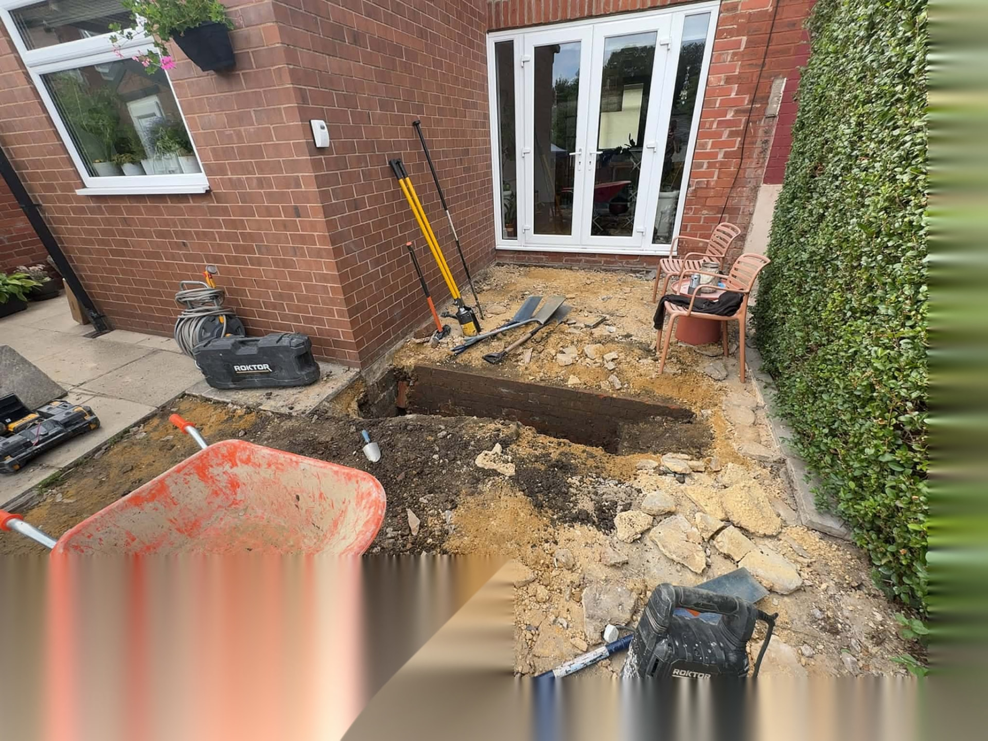 Patio area excavated back to formation level beside French doors ready for a new sub-base