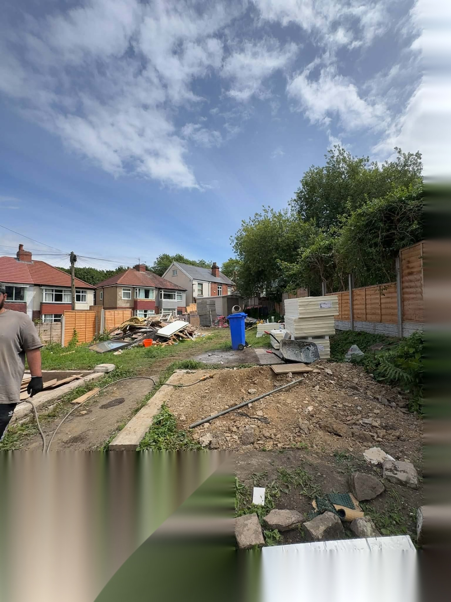Garden set up as a working groundworks site with spoil and materials stored tidily